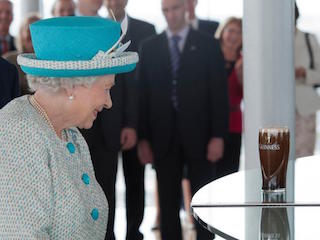 This is a photo of the Queen Elizabeth 2 in front of a Guinness beer in the Guinness Store