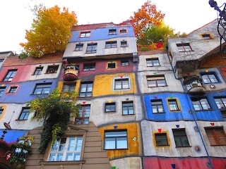 this image shows you hundertwasserghaus, a beautiful multi-colours establishment. 